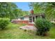 Exterior view of the home showcases a well-maintained lawn and a brick patio at 3800 Whitaker Ln, Lithia Springs, GA 30122