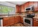 Charming kitchen featuring stainless steel appliances and stone tile backsplash at 3800 Whitaker Ln, Lithia Springs, GA 30122