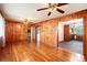 Large living room with hardwood floors, adjacent to the kitchen and with a laundry area at 3800 Whitaker Ln, Lithia Springs, GA 30122