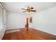 Cozy living room featuring hardwood floors and a decorative ceiling fan with easy access to other rooms at 3800 Whitaker Ln, Lithia Springs, GA 30122