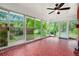 Bright sun room features sliding glass doors to the backyard and unique red tile flooring at 3800 Whitaker Ln, Lithia Springs, GA 30122