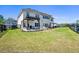 Expansive backyard featuring a patio area with pergola, grassy lawn, and fenced perimeter at 4105 Woodwind Dr, Cumming, GA 30028