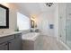 Modern bathroom with a soaking tub, glass shower, and stylish vanity at 4105 Woodwind Dr, Cumming, GA 30028