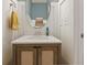 Charming powder room with decorative mirror and updated vanity at 4105 Woodwind Dr, Cumming, GA 30028