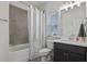 Tiled bathroom featuring a shower, a bathtub, and a dark vanity with ample counter space at 4105 Woodwind Dr, Cumming, GA 30028