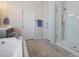 Bright bathroom with a soaking tub, glass shower, and modern fixtures at 4105 Woodwind Dr, Cumming, GA 30028