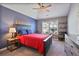 Blue and gray bedroom featuring a tray ceiling, ceiling fan, and stylish furnishings at 4105 Woodwind Dr, Cumming, GA 30028