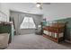Cozy Bedroom featuring a crib, chair, and stylish decor at 4105 Woodwind Dr, Cumming, GA 30028
