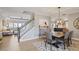 Open-concept dining area with modern chandelier and staircase at 4105 Woodwind Dr, Cumming, GA 30028