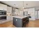 Gourmet kitchen with stainless appliances, custom cabinetry, and a large center island at 4105 Woodwind Dr, Cumming, GA 30028