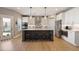 Spacious kitchen features a center island with barstool seating and pendant lighting at 4105 Woodwind Dr, Cumming, GA 30028