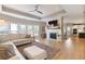 Spacious living room with fireplace, large windows and open to kitchen at 4105 Woodwind Dr, Cumming, GA 30028
