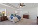 Serene main bedroom suite featuring a tray ceiling and plush carpet at 4105 Woodwind Dr, Cumming, GA 30028