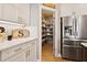A view into a well-organized pantry with shelves stocked full of goods at 4105 Woodwind Dr, Cumming, GA 30028