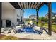 Outdoor patio area with comfortable seating under a pergola, perfect for entertaining at 4105 Woodwind Dr, Cumming, GA 30028