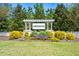 Community sign surrounded by colorful flowers and lush greenery, welcoming you to Lake Haven at 4105 Woodwind Dr, Cumming, GA 30028