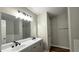 Bathroom featuring a dual sink vanity, a glass shower, and a large mirror at 5169 Hanover St, Atlanta, GA 30349