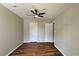 This bedroom features wood-look floors, a ceiling fan and two closets for ample storage at 5169 Hanover St, Atlanta, GA 30349
