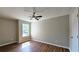 Bright bedroom featuring wood-look floors, ceiling fan and a window allowing natural light at 5169 Hanover St, Atlanta, GA 30349