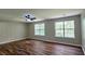 Spacious bedroom featuring luxury vinyl flooring, ceiling fan, and double windows at 5169 Hanover St, Atlanta, GA 30349