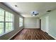Large bedroom with luxury vinyl flooring, double windows, and an overhead fan at 5169 Hanover St, Atlanta, GA 30349