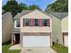 Charming home with stone accents, a two-car garage, and manicured lawn at 5169 Hanover St, Atlanta, GA 30349