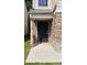 Close up of entryway with charming stone facade and black metal door at 5169 Hanover St, Atlanta, GA 30349