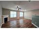 Spacious living room with fireplace, ceiling fan, and wood-look flooring at 5169 Hanover St, Atlanta, GA 30349