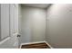 Walk-in closet with luxury vinyl flooring, white walls, and convenient hanging racks at 5169 Hanover St, Atlanta, GA 30349