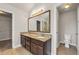 Primary bathroom with double vanity, granite countertops, tile floors, and walk-in closet access at 1285 Brynhill Ct, Buford, GA 30518