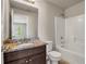 Bright bathroom with granite countertop, wood cabinets, tub, and tiled floors at 1285 Brynhill Ct, Buford, GA 30518