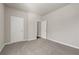Empty bedroom with carpet flooring, two doors, and neutral wall colors at 1285 Brynhill Ct, Buford, GA 30518