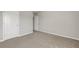 Bright bedroom with neutral carpeting, white trim, and ample closet space at 1285 Brynhill Ct, Buford, GA 30518