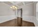 Bright, spacious dining room with hardwood floors, coffered ceiling, and chandelier at 1285 Brynhill Ct, Buford, GA 30518