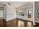 Bright dining area with wainscoting, hardwood floors, and a view to the outdoor deck at 1285 Brynhill Ct, Buford, GA 30518