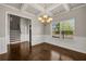 Bright, spacious dining room with hardwood floors, coffered ceiling, and chandelier at 1285 Brynhill Ct, Buford, GA 30518