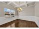 Bright, spacious dining room with hardwood floors, coffered ceiling, and chandelier at 1285 Brynhill Ct, Buford, GA 30518