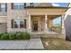 Inviting front porch featuring brick columns and covered entry with sidelights at 1285 Brynhill Ct, Buford, GA 30518
