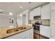 Close-up on the kitchen featuring a central island, stainless steel appliances, and granite countertops at 1285 Brynhill Ct, Buford, GA 30518