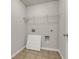 Laundry room with tile flooring, utility hook-ups, and wire shelving at 1285 Brynhill Ct, Buford, GA 30518