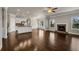 Spacious living room with hardwood floors, stone fireplace, and an open layout to the kitchen at 1285 Brynhill Ct, Buford, GA 30518