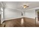 Hardwood floor living room with a ceiling fan and generous natural light at 1285 Brynhill Ct, Buford, GA 30518