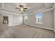 Bright main bedroom with large windows, neutral carpeting, and double tray ceilings at 1285 Brynhill Ct, Buford, GA 30518