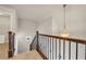 Detailed wrought iron staircase with decorative chandelier and neutral carpeting at 1285 Brynhill Ct, Buford, GA 30518