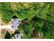 Overhead view of a well-maintained home nestled among lush trees, offering a serene and private setting at 1326 Benbrooke Nw Ln, Acworth, GA 30101