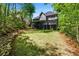 Expansive backyard with lush green lawn, perfect for outdoor activities and relaxation, surrounded by mature trees at 1326 Benbrooke Nw Ln, Acworth, GA 30101