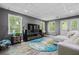 Finished basement with stylish seating, windows with natural light, and vinyl flooring at 1326 Benbrooke Nw Ln, Acworth, GA 30101