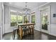 Charming dining area with modern lighting, windows and views of the trees at 1326 Benbrooke Nw Ln, Acworth, GA 30101