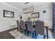 Elegant dining room with stylish lighting, wainscoting, and hardwood floors at 1326 Benbrooke Nw Ln, Acworth, GA 30101