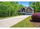 Long driveway leading to a beautifully landscaped home with lush greenery and mature trees at 1326 Benbrooke Nw Ln, Acworth, GA 30101